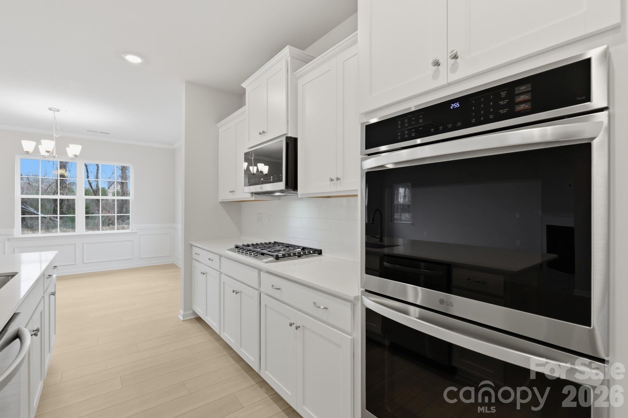 5450 Redbud Road, Unit 66 Lancaster, SC 29720 - Photo 19 of 35 a kitchen with stainless steel appliances a stove microwave and cabinets