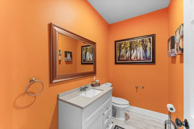 a bathroom with a toilet a sink and mirror