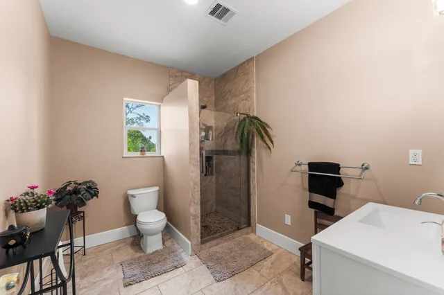 a bathroom with a toilet and a shower