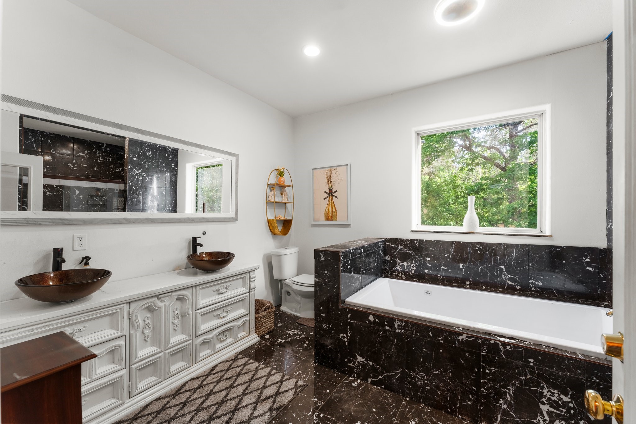 11053 Heritage Ranch Road Conroe, TX 77303 - Photo 30 of 42 a bathroom with a bathtub a sink a window and a shower