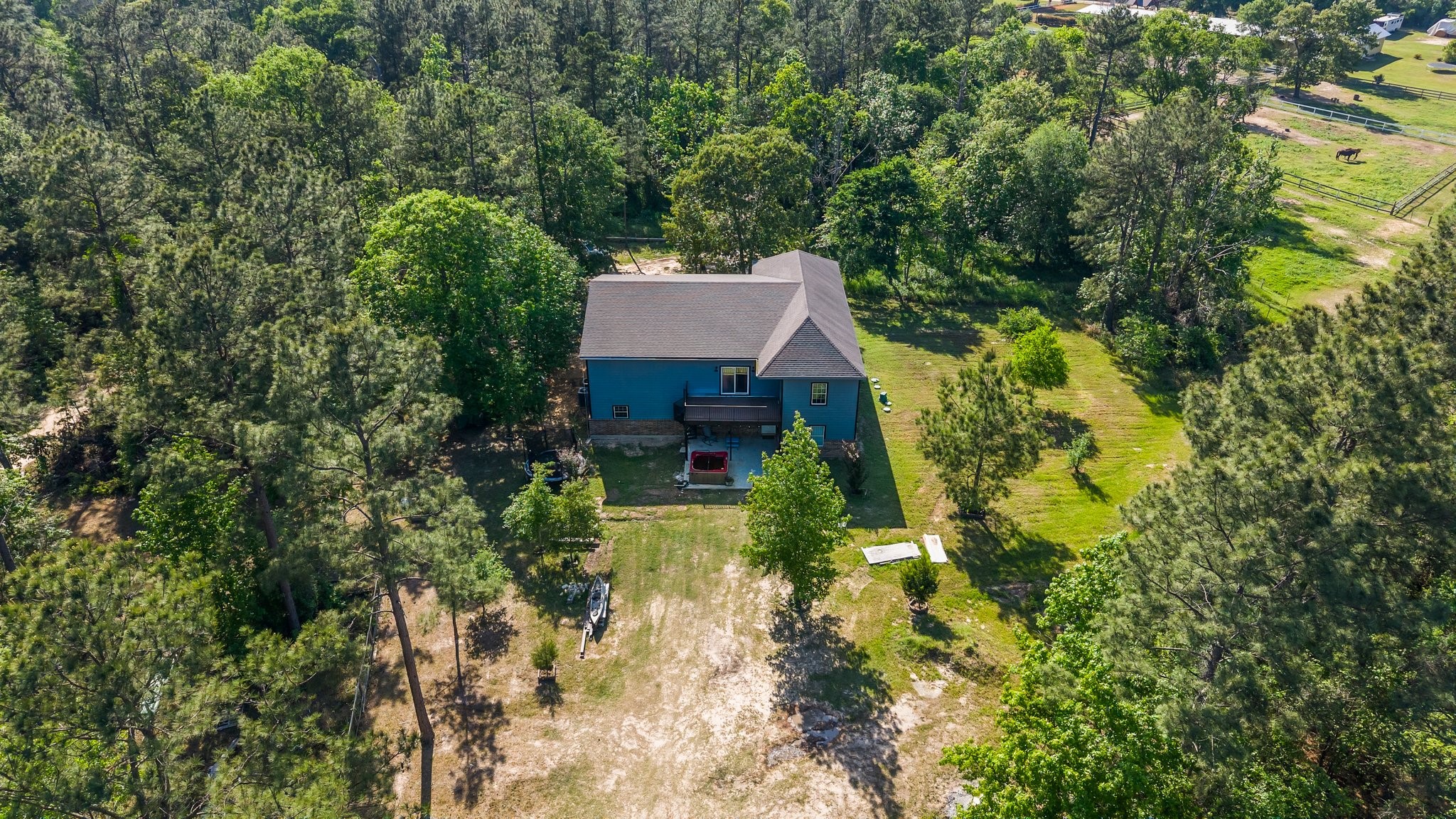 11053 Heritage Ranch Road Conroe, TX 77303 - Photo 39 of 42 a aerial view of a house with swimming pool and lawn chairs under an umbrella