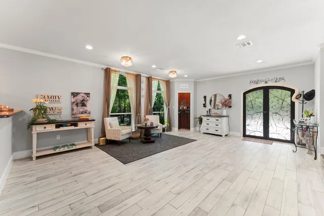 a large white room with furniture and a large window