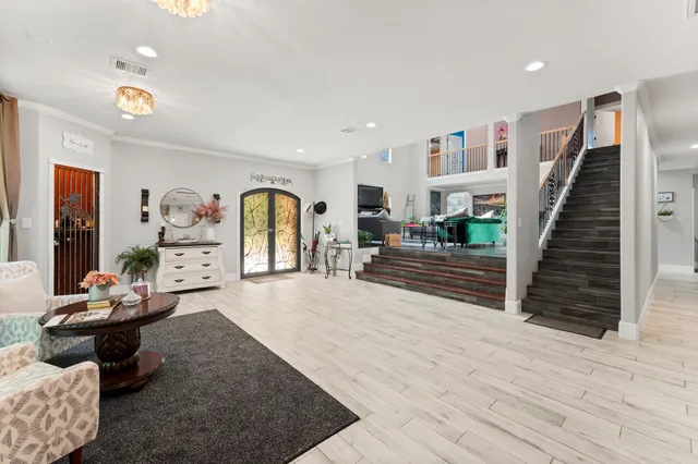 a living room with furniture and wooden floor