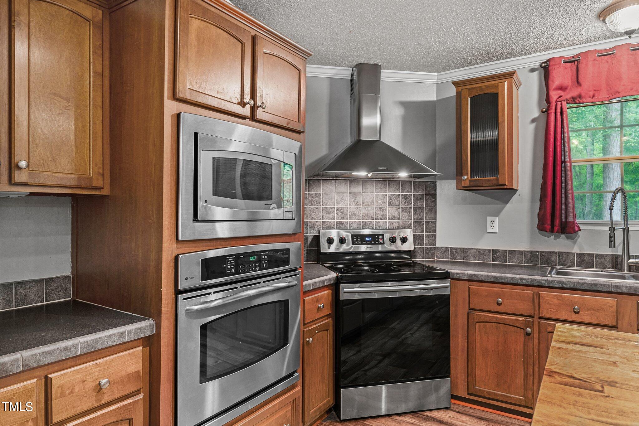 150 Box Elder Terrace Cameron, NC 28326 - Photo 14 of 23 a kitchen with granite countertop a stove and a sink