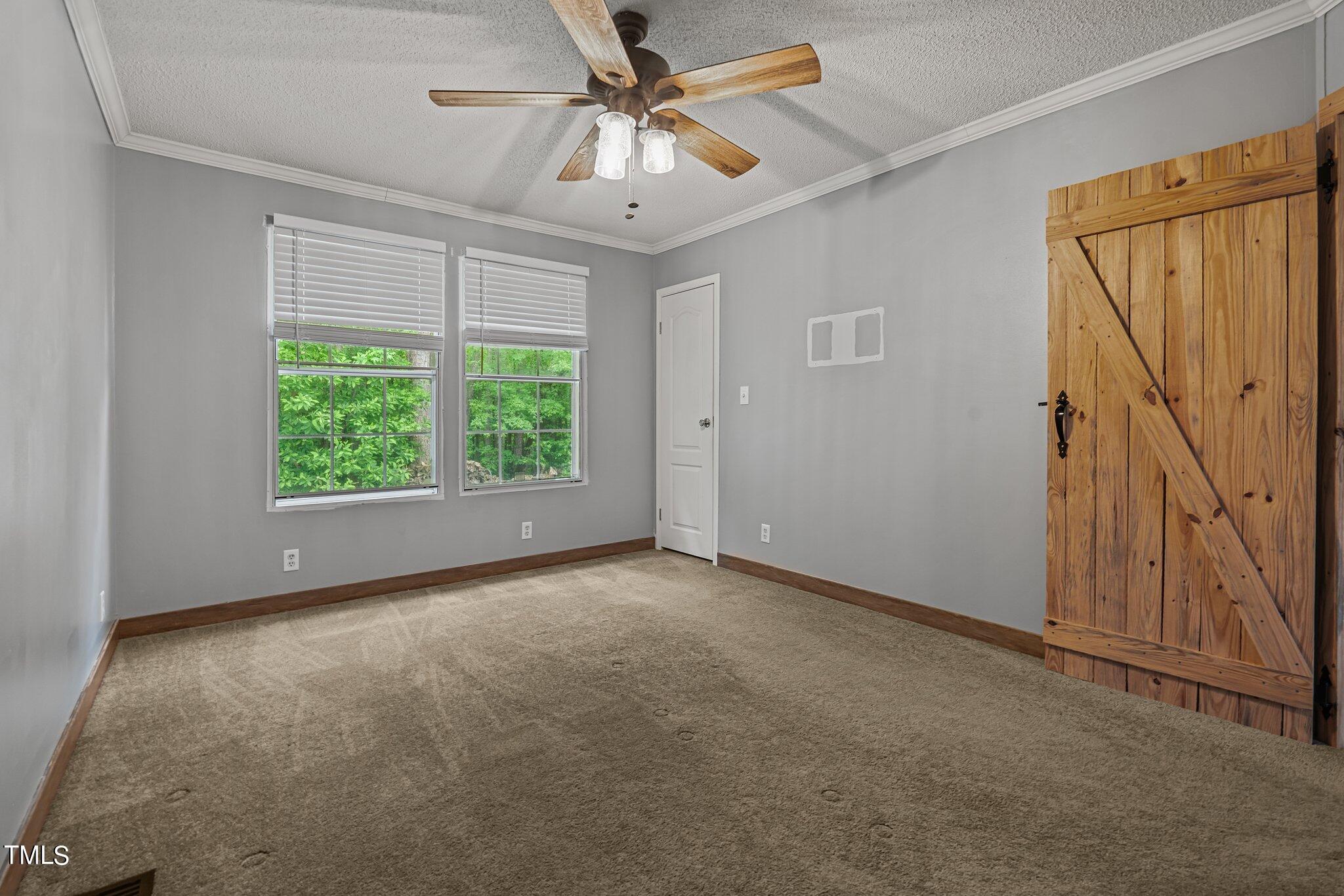 150 Box Elder Terrace Cameron, NC 28326 - Photo 17 of 23 an empty room with windows and fan