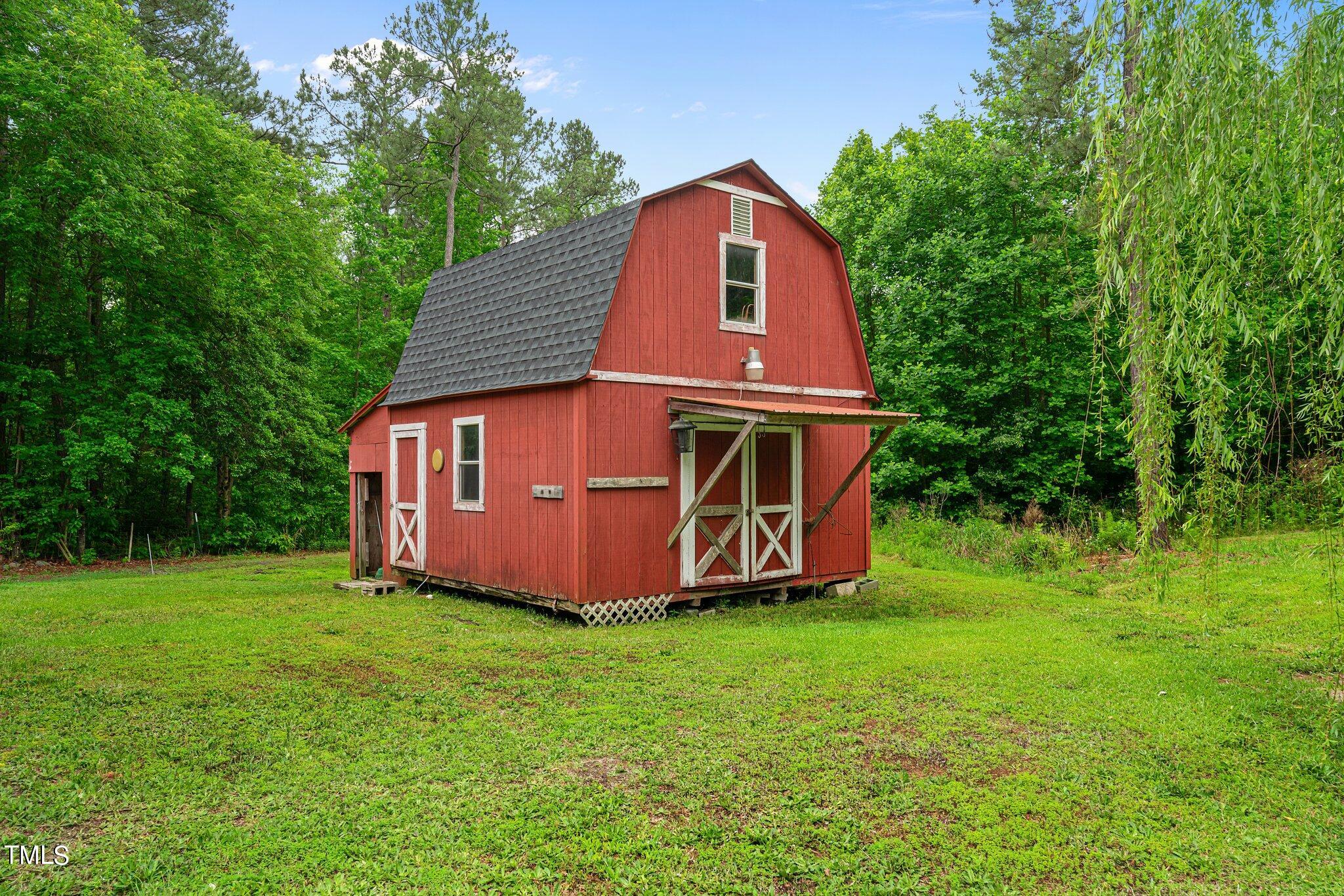 150 Box Elder Terrace Cameron, NC 28326 - Photo 21 of 23 a view of a backyard with a garden and entertaining space