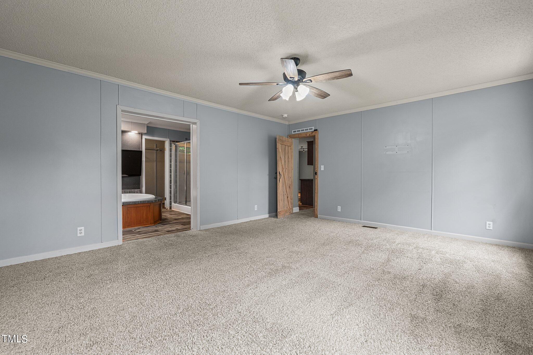 150 Box Elder Terrace Cameron, NC 28326 - Photo 6 of 23 a view of an empty room with a ceiling fan