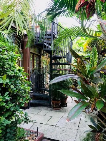 a front view of multi story residential apartment building with yard and green space