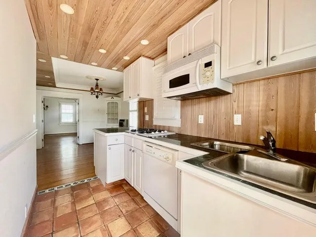 a kitchen with stainless steel appliances granite countertop a sink and cabinets