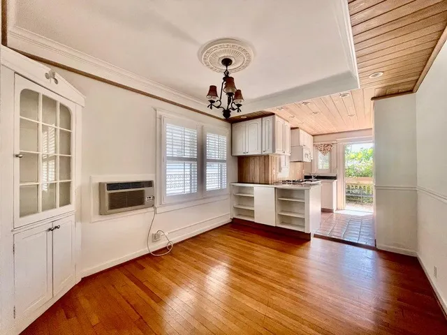 a view of a kitchen with stove and cabinets
