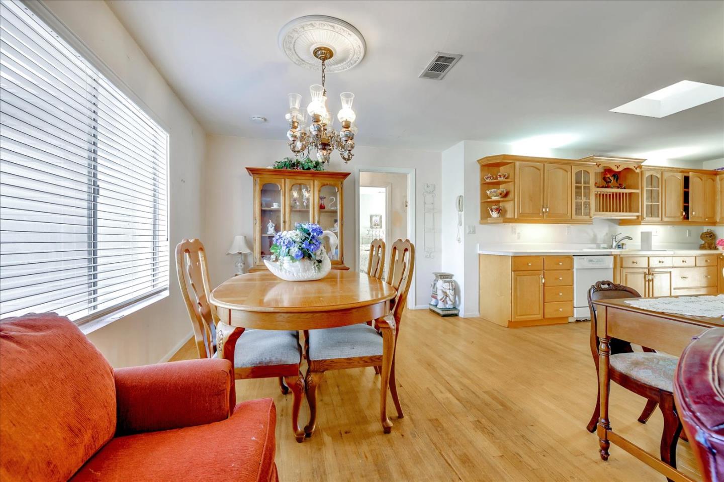 679 Sleeper Avenue Mountain View, CA 94040 - Photo 35 of 51 a view of a dining room with furniture a chandelier and wooden floor