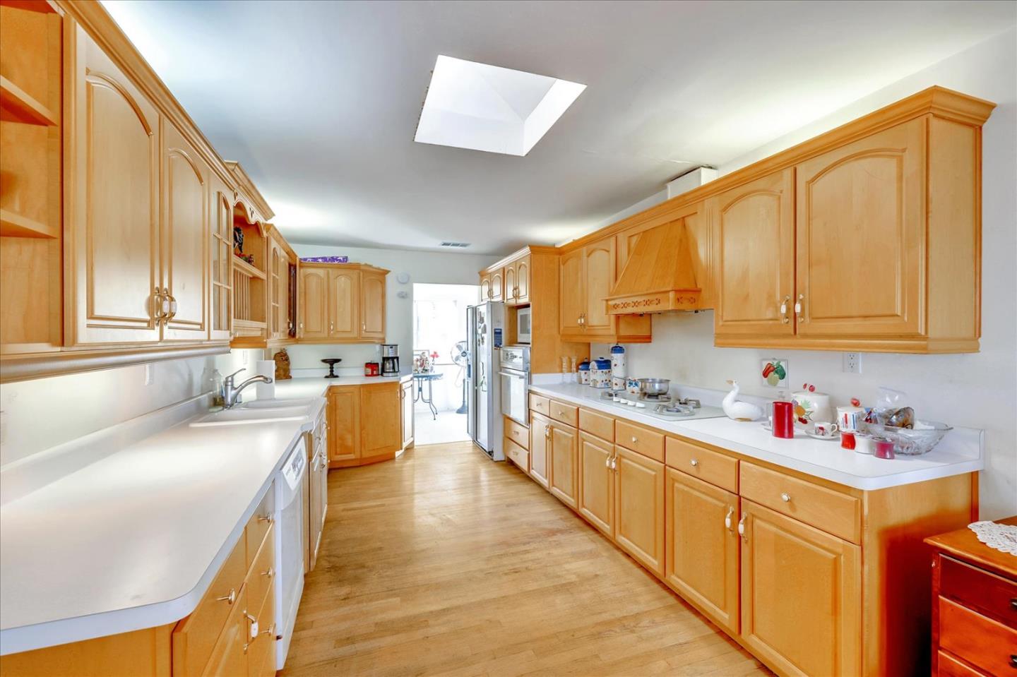679 Sleeper Avenue Mountain View, CA 94040 - Photo 36 of 51 a large kitchen with stainless steel appliances granite countertop a lot of counter space and wooden floors