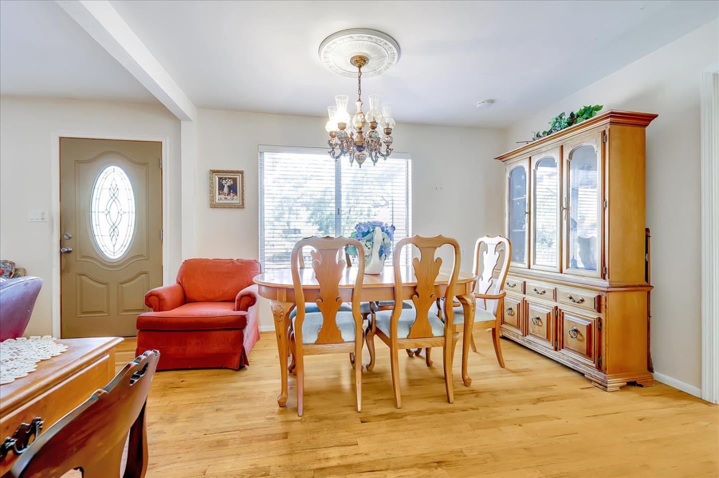 679 Sleeper Avenue Mountain View, CA 94040 - Photo 41 of 51 a dining room with furniture a chandelier and wooden floor