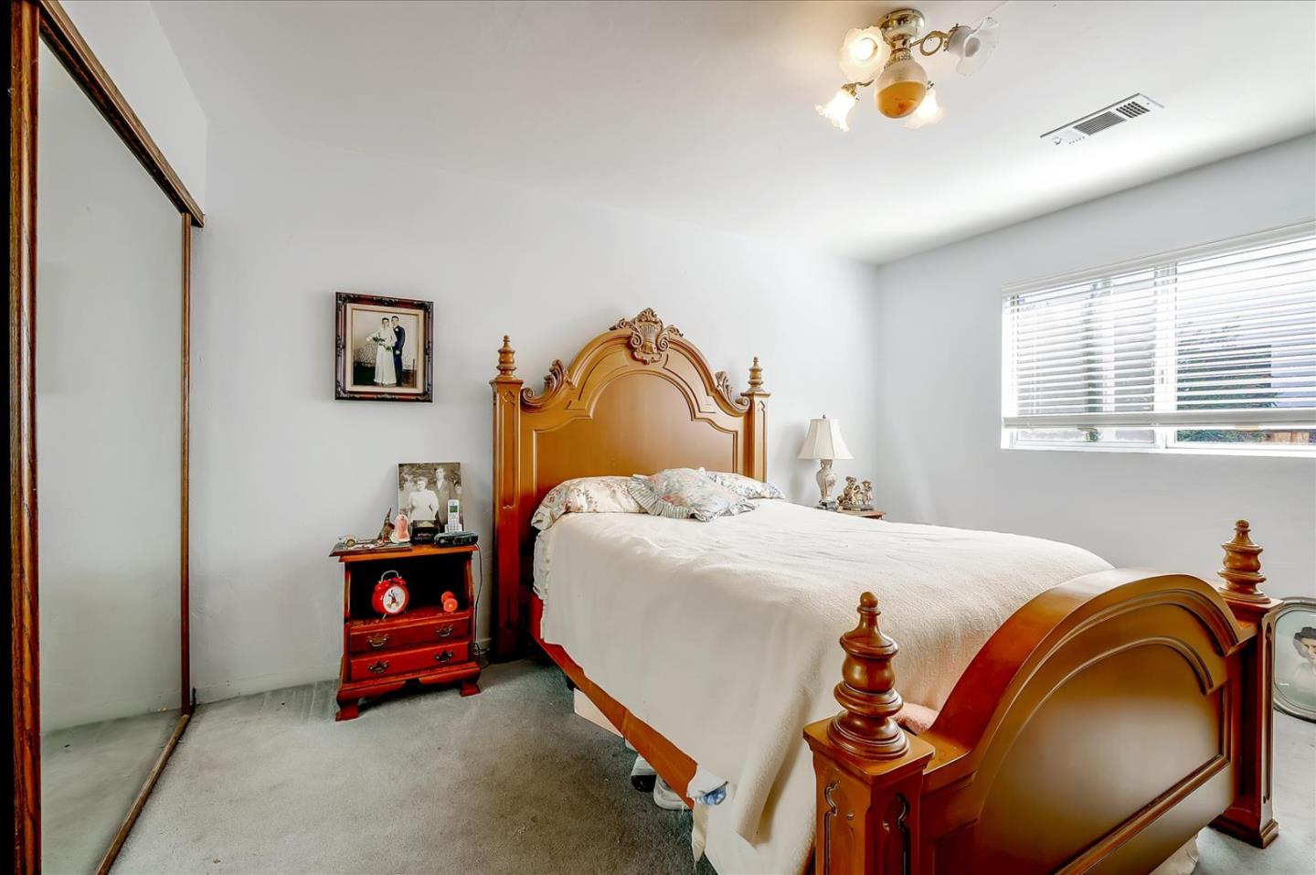 679 Sleeper Avenue Mountain View, CA 94040 - Photo 42 of 51 a bedroom with a bed and a chandelier