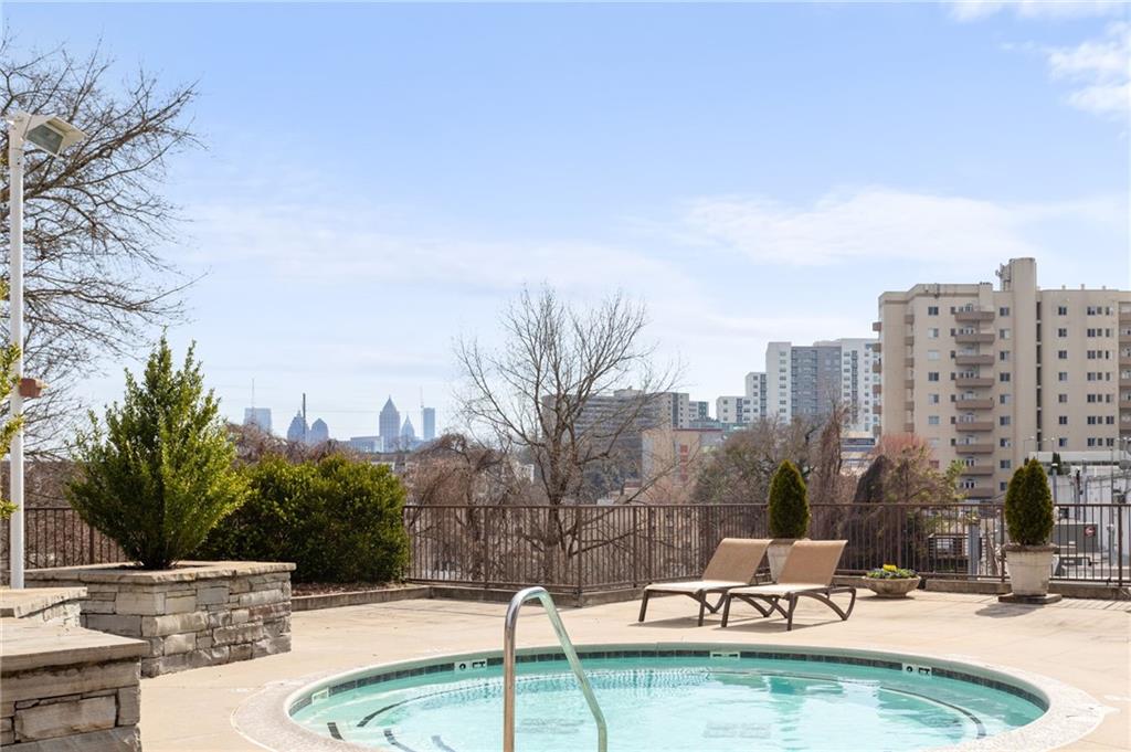 2255 Peachtree Road Northeast, Unit 326 Atlanta, GA 30309 - Photo 24 of 37 a swimming pool with outdoor seating and yard