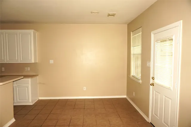 a view of a room with wooden floor and fan