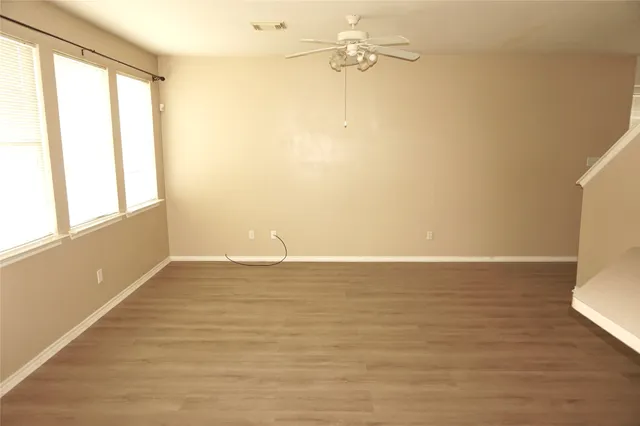 a kitchen with stainless steel appliances granite countertop a sink and white cabinets