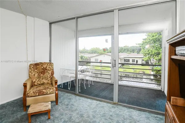 a view of a livingroom with furniture and a window
