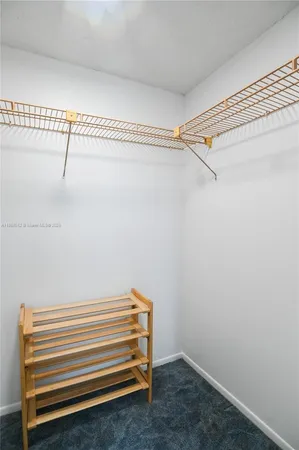 a bedroom with a bed and a chandelier fan