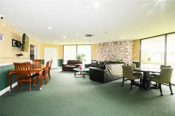 a living room with furniture pool table and a pool table