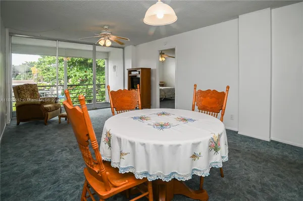 a view of a livingroom with furniture and a ceiling fan