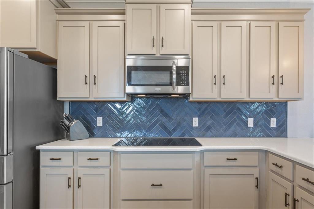101 Rancho Lorena Drive Lorena, TX 76655 - Photo 18 of 40 a kitchen with granite countertop white cabinets and white appliances