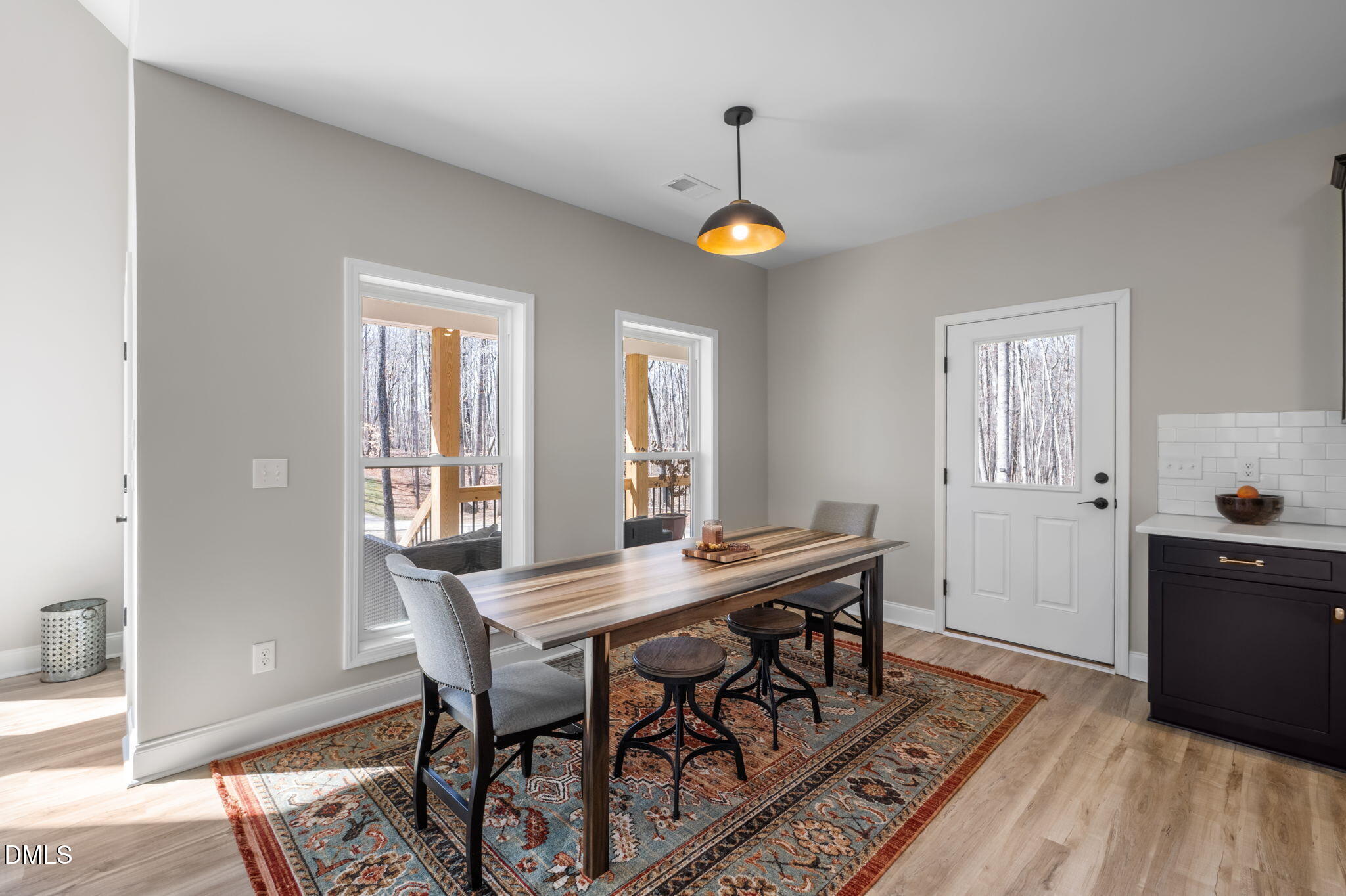 8514 Charlie Stovall Road Roxboro, NC 27574 - Photo 17 of 48 a view of a dining room with furniture and wooden floor