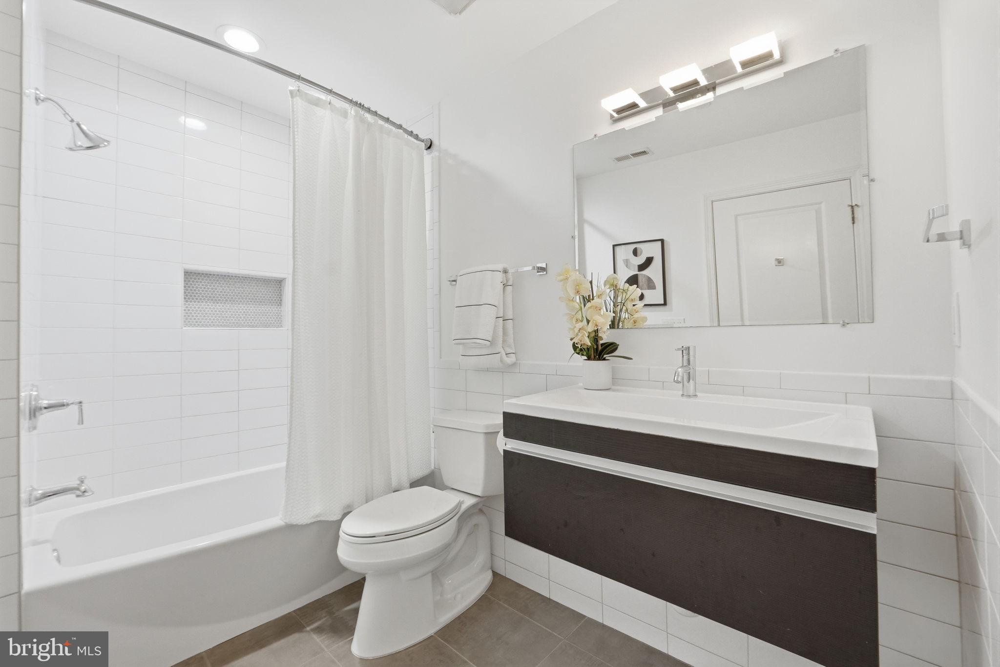 1126 5th Street Northwest, Unit 1 Washington, DC 20001 - Photo 15 of 27 a bathroom with a sink a toilet and shower