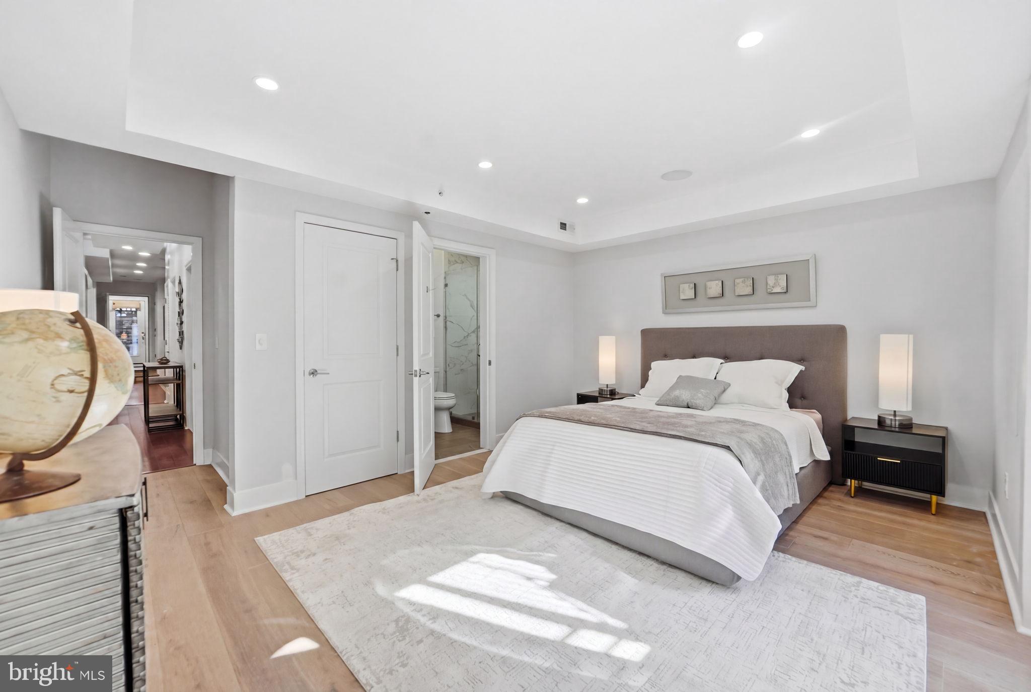1126 5th Street Northwest, Unit 1 Washington, DC 20001 - Photo 17 of 27 a bed room with a bed a mirror and a lamp