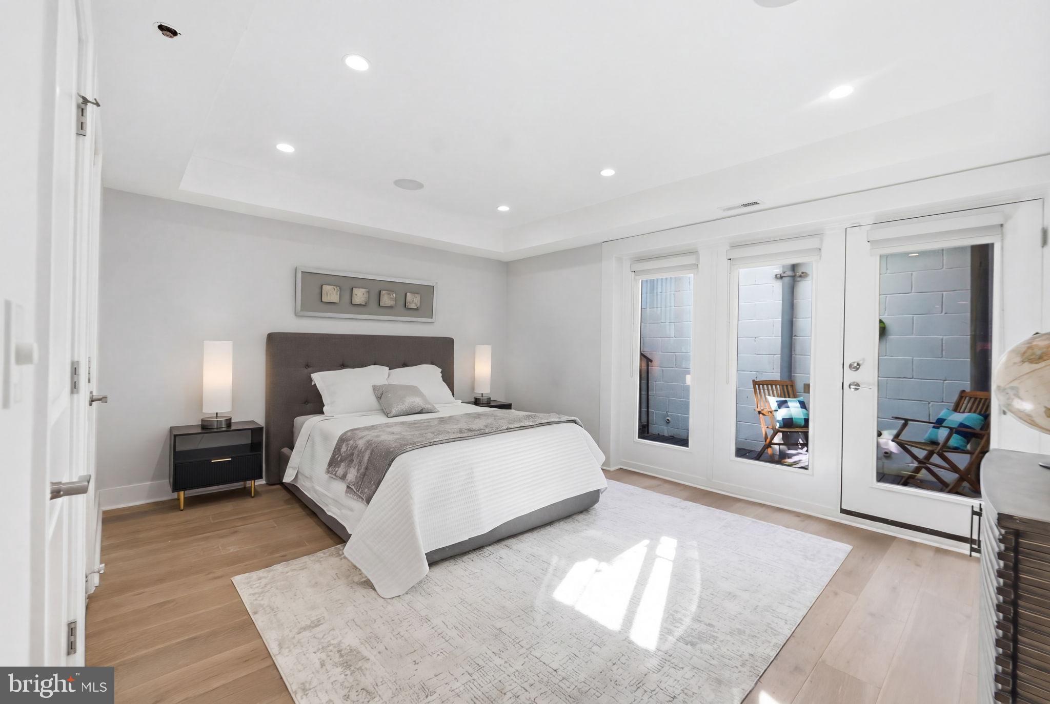 1126 5th Street Northwest, Unit 1 Washington, DC 20001 - Photo 18 of 27 a spacious bedroom with a large bed and a couch
