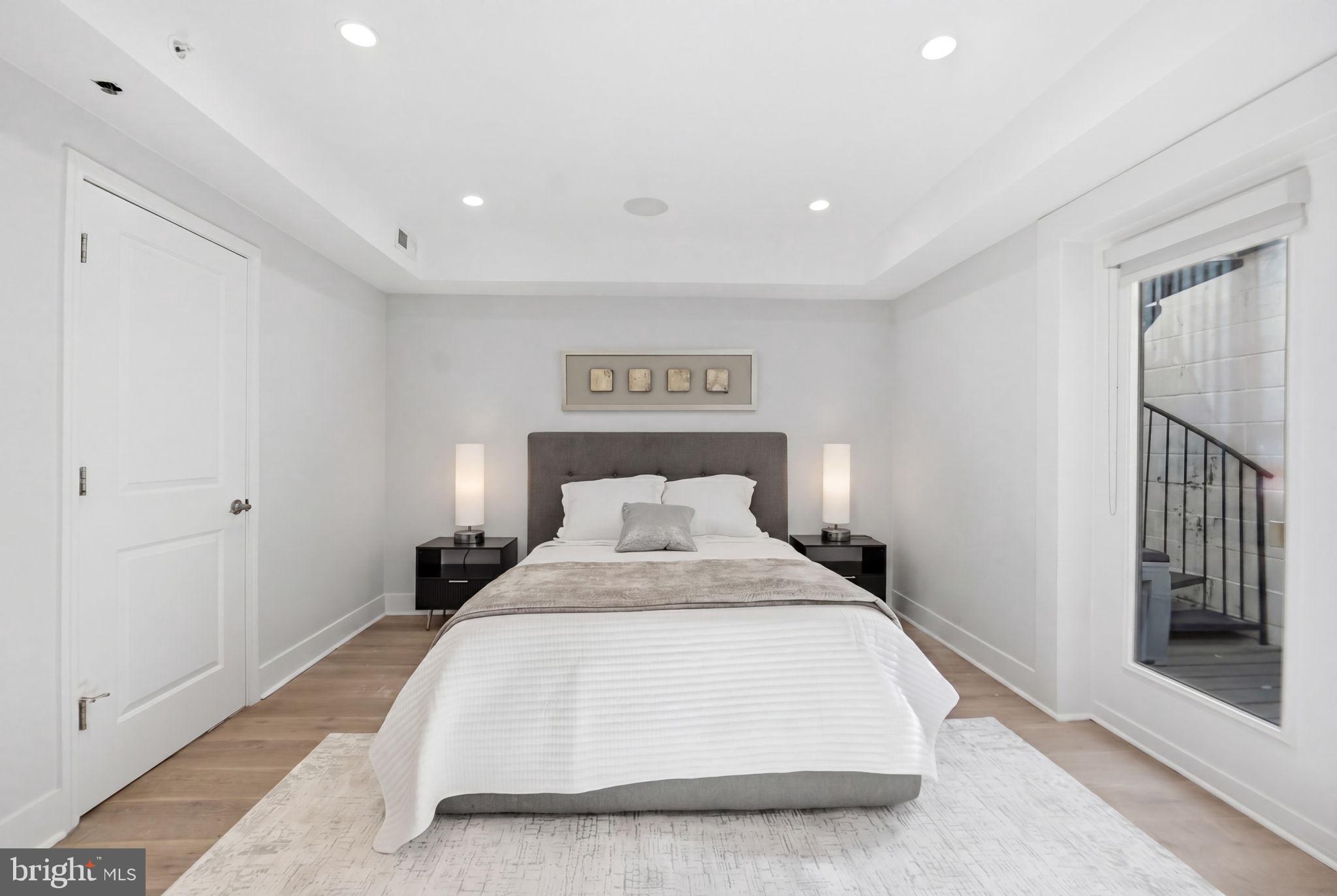 1126 5th Street Northwest, Unit 1 Washington, DC 20001 - Photo 19 of 27 a spacious bedroom with a bed and a large mirror