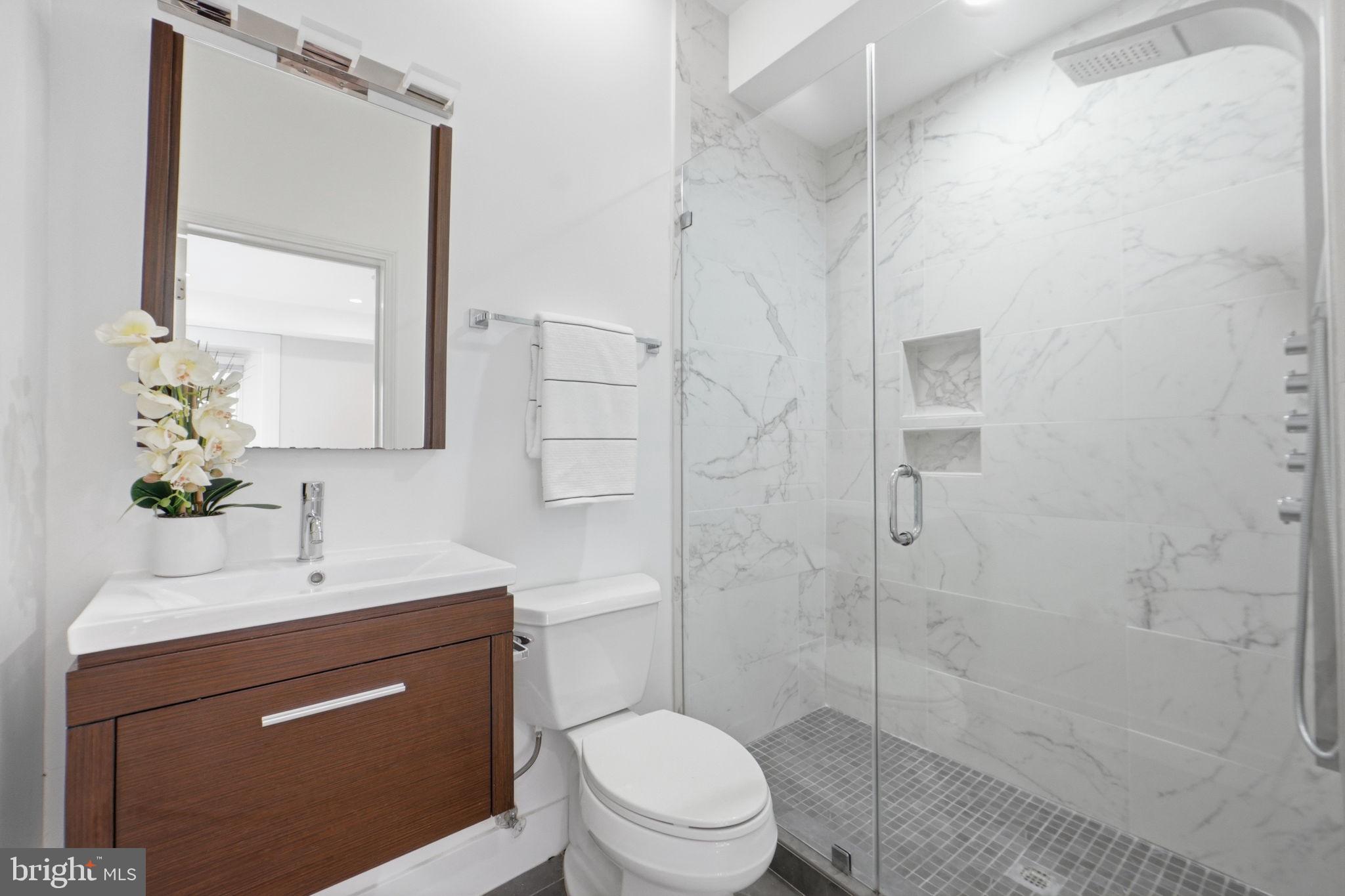 1126 5th Street Northwest, Unit 1 Washington, DC 20001 - Photo 21 of 27 a bathroom with a sink a toilet and shower