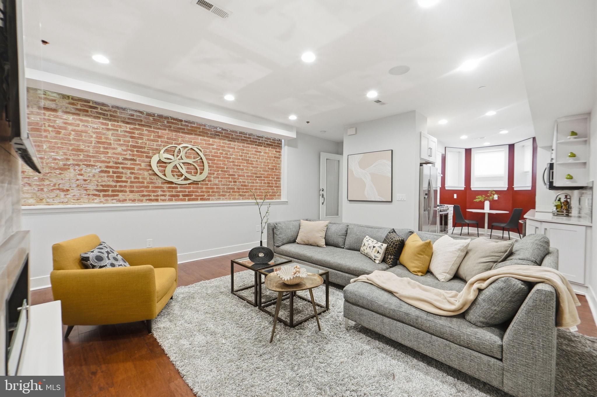 1126 5th Street Northwest, Unit 1 Washington, DC 20001 - Photo 7 of 27 a living room with furniture and kitchen view