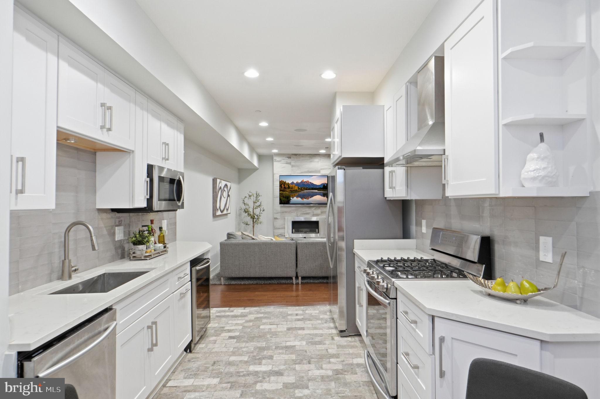 1126 5th Street Northwest, Unit 1 Washington, DC 20001 - Photo 8 of 27 a kitchen with stainless steel appliances granite countertop a sink stove and refrigerator