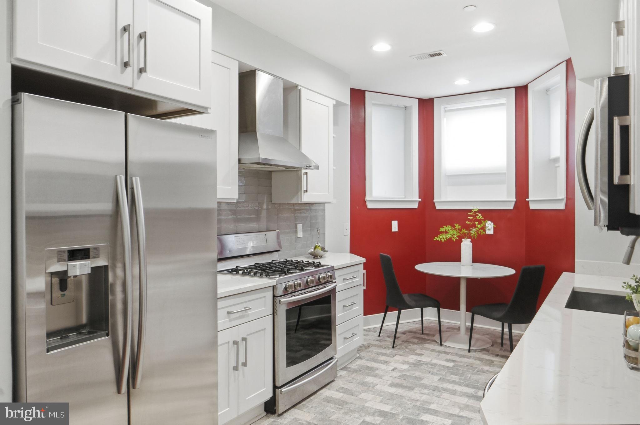 1126 5th Street Northwest, Unit 1 Washington, DC 20001 - Photo 9 of 27 a kitchen with stainless steel appliances granite countertop a stove a refrigerator and a sink