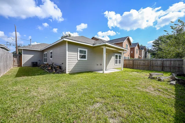a backyard of a house with table and chairs