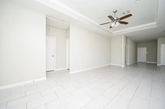 a view of a livingroom with a ceiling fan and window