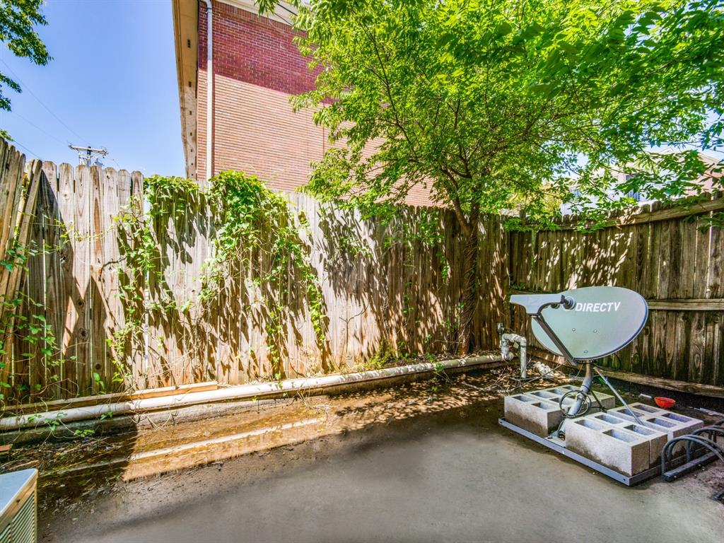 929 West Hickory Street, Unit A13 Denton, TX 76201 - Photo 12 of 12 a backyard of a house with barbeque oven table and chairs