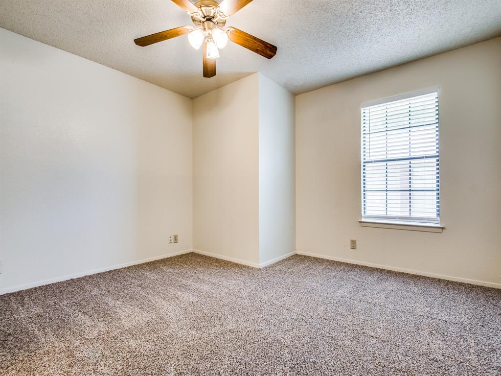 929 West Hickory Street, Unit A13 Denton, TX 76201 - Photo 7 of 12 an empty room with windows and fan