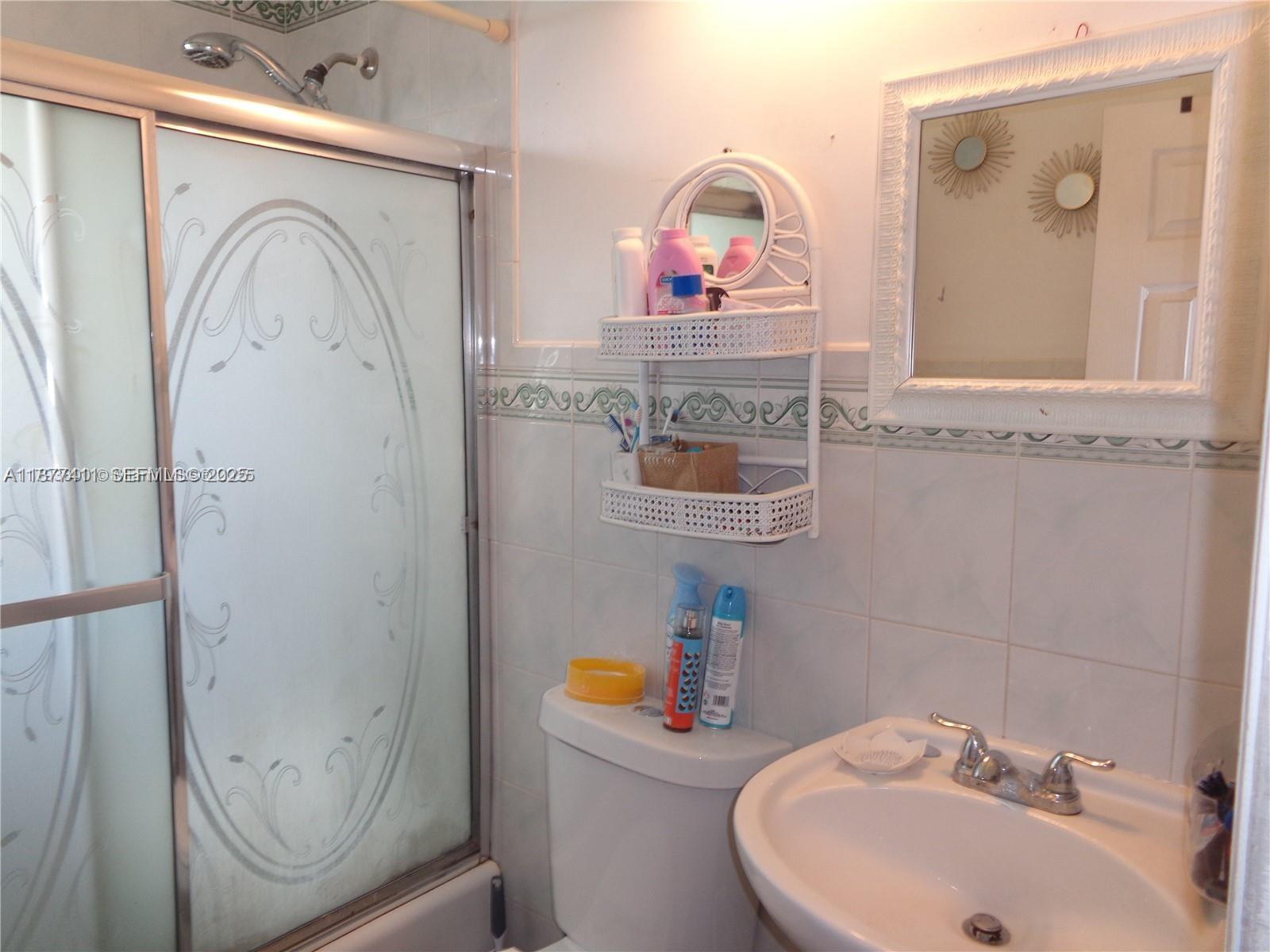 10020 Dominican Drive Cutler Bay, FL 33189 - Photo 9 of 22 a bathroom with a sink mirror toilet and vanity