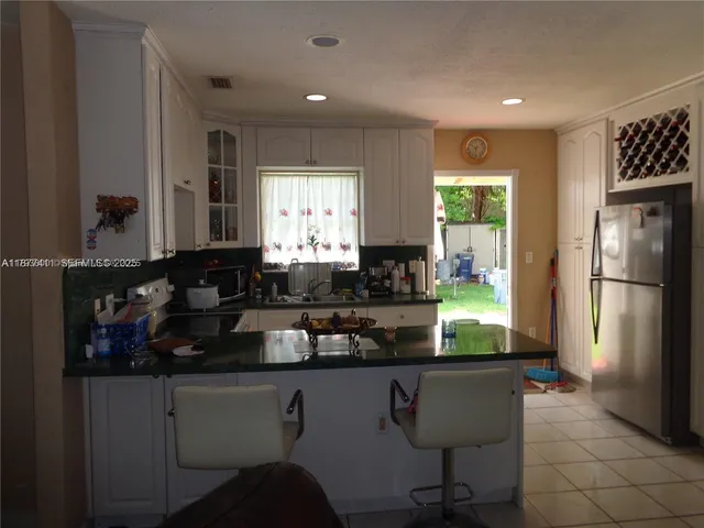 a kitchen with a sink a stove and cabinets