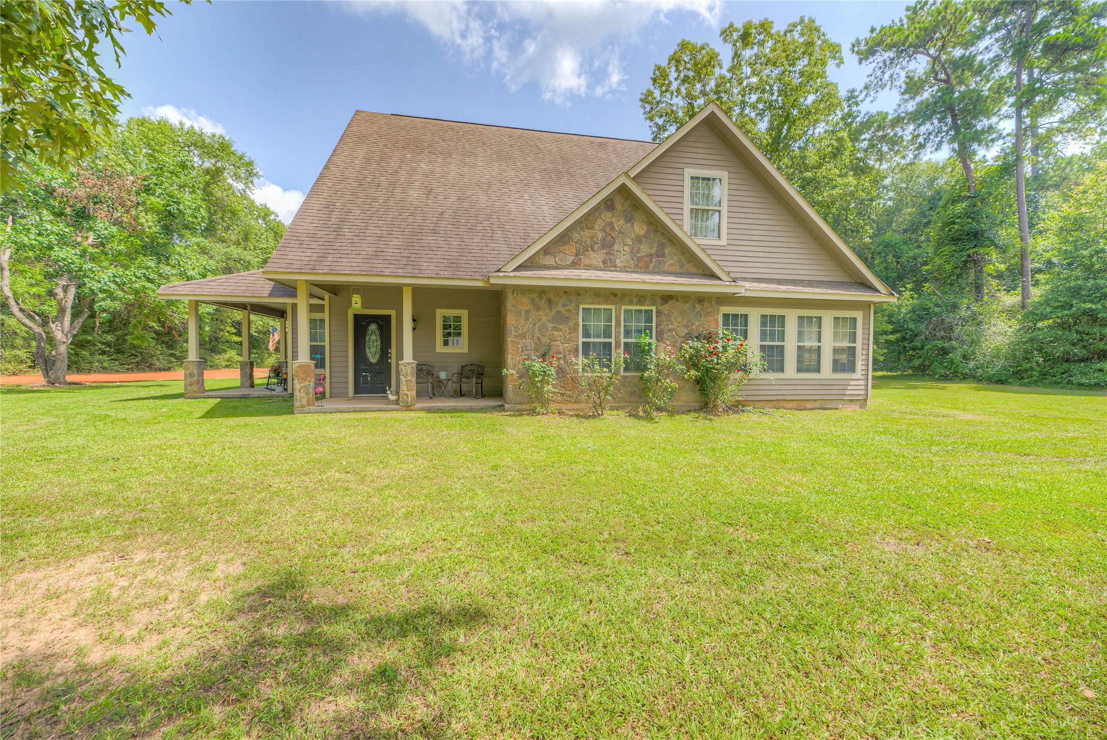 a front view of house with yard and green space