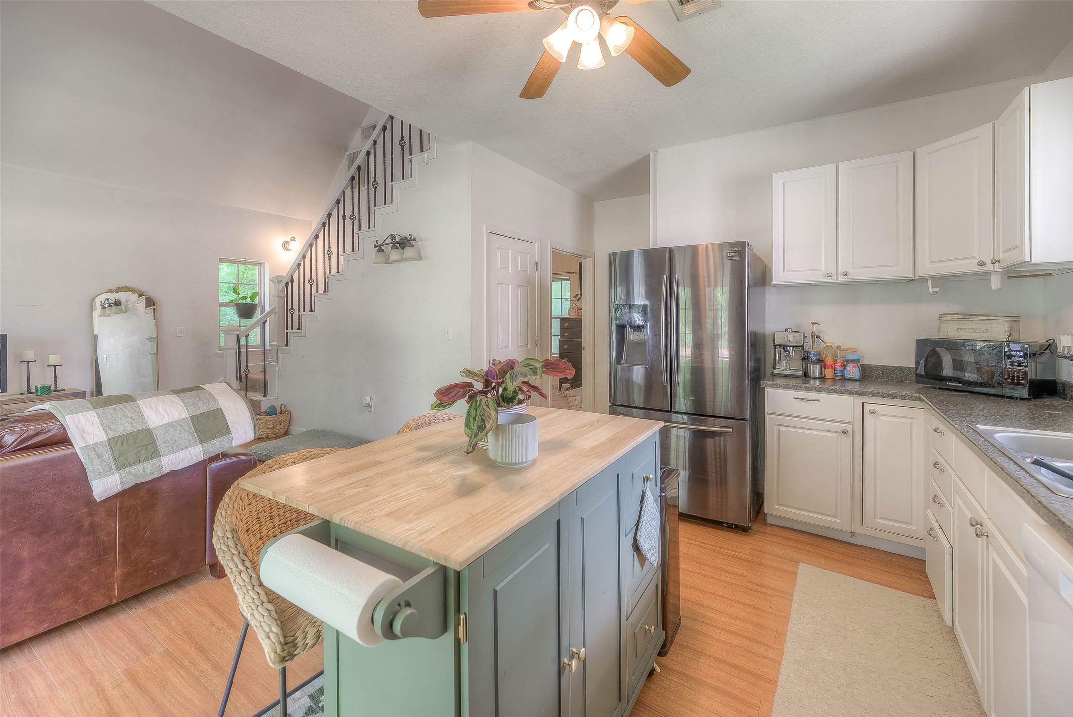 110 Happy Trails Road Coldspring, TX 77331 - Photo 20 of 49 a kitchen with stainless steel appliances granite countertop a sink refrigerator and cabinets