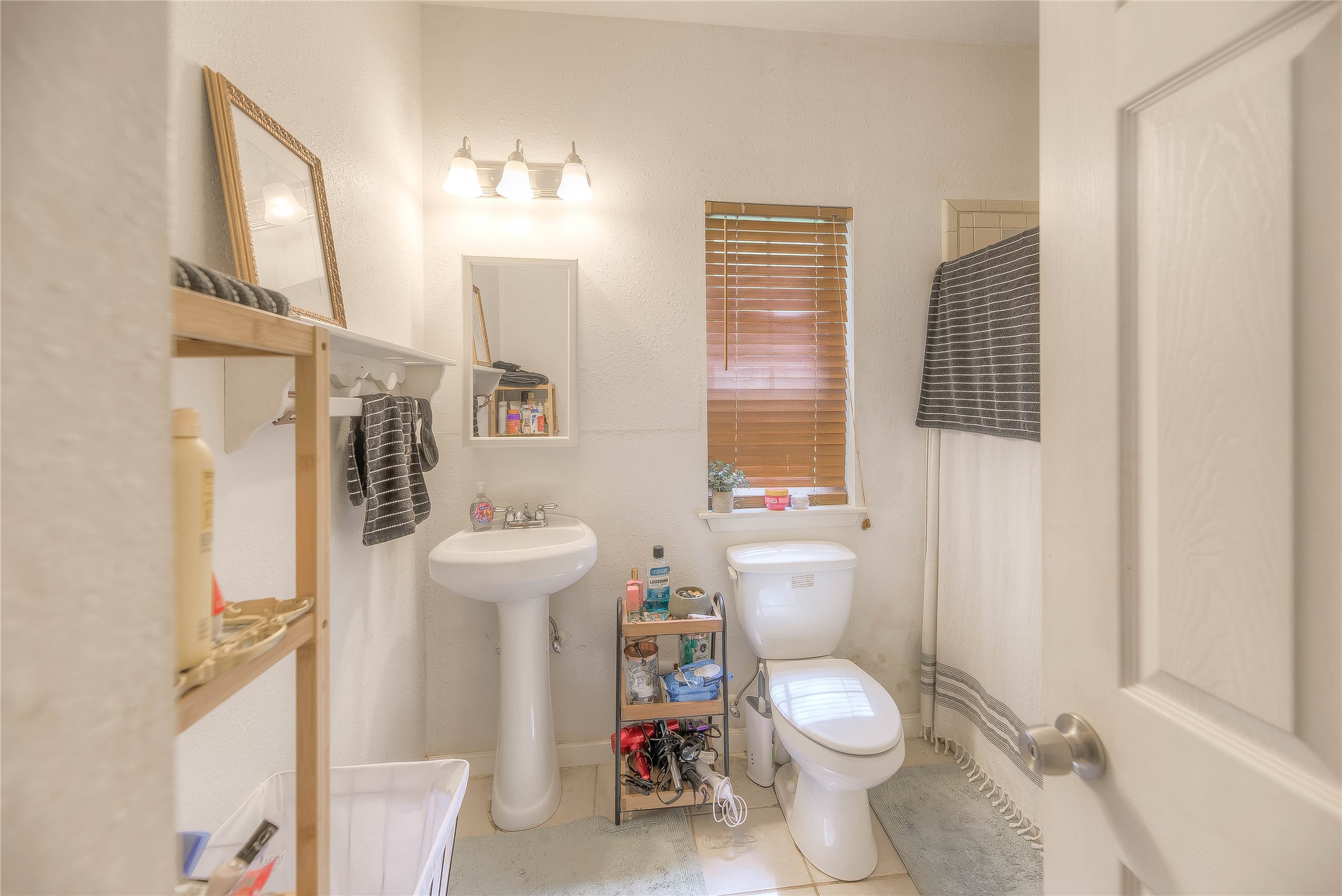 110 Happy Trails Road Coldspring, TX 77331 - Photo 25 of 49 a white toilet sitting next to a bathroom sink and a window