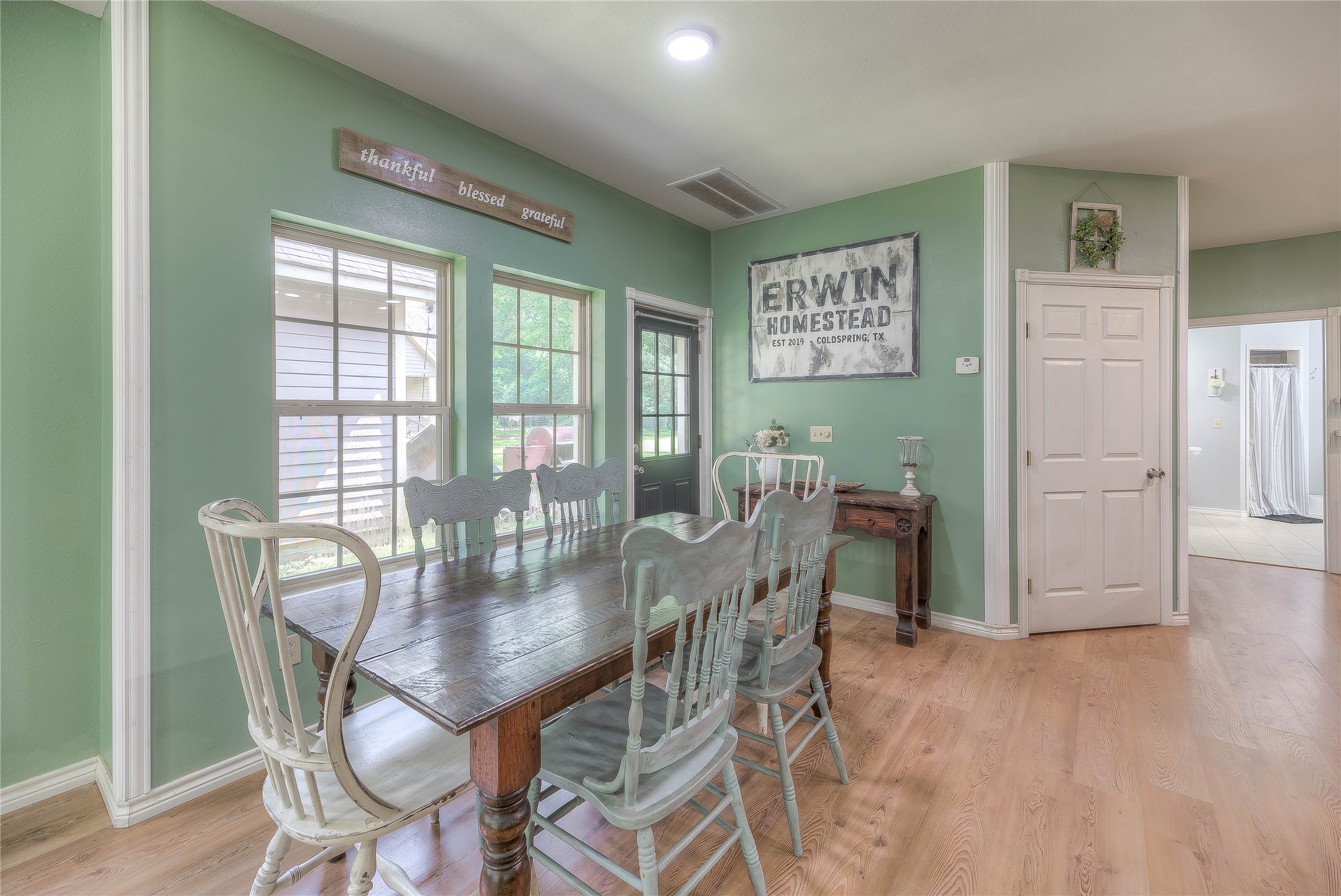 110 Happy Trails Road Coldspring, TX 77331 - Photo 4 of 49 a view of a dining room with furniture and wooden floor