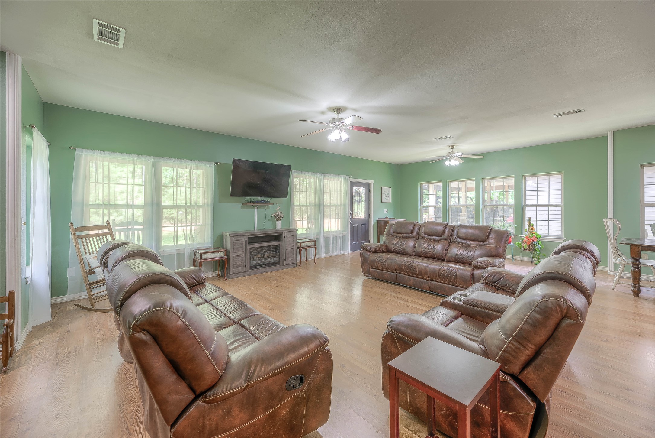 110 Happy Trails Road Coldspring, TX 77331 - Photo 7 of 49 a living room with furniture a ceiling fan and a flat screen tv