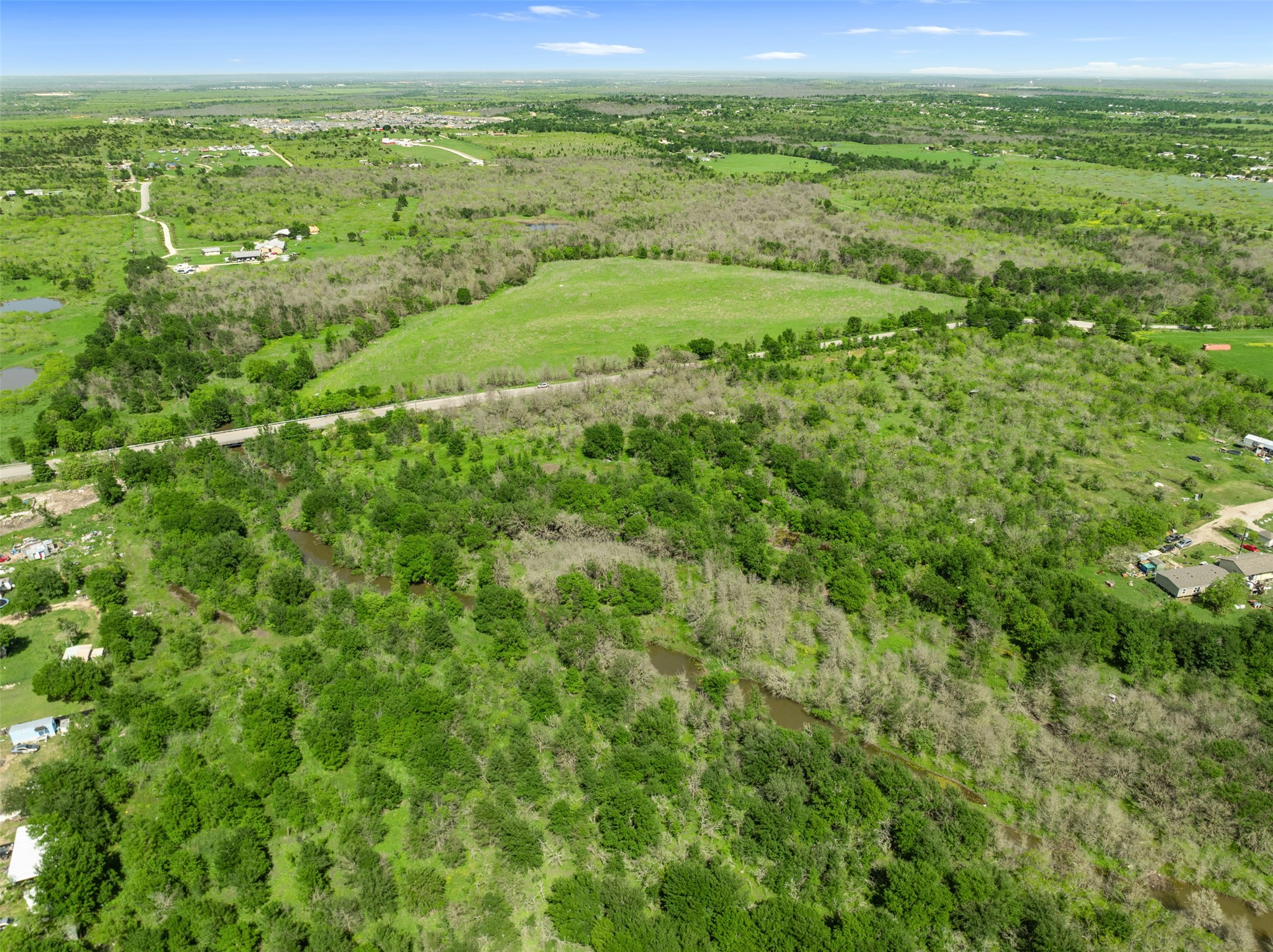 0 Jacobson Road Del Valle, TX 78617 - Photo 11 of 40 a view of a green field with lots of bushes