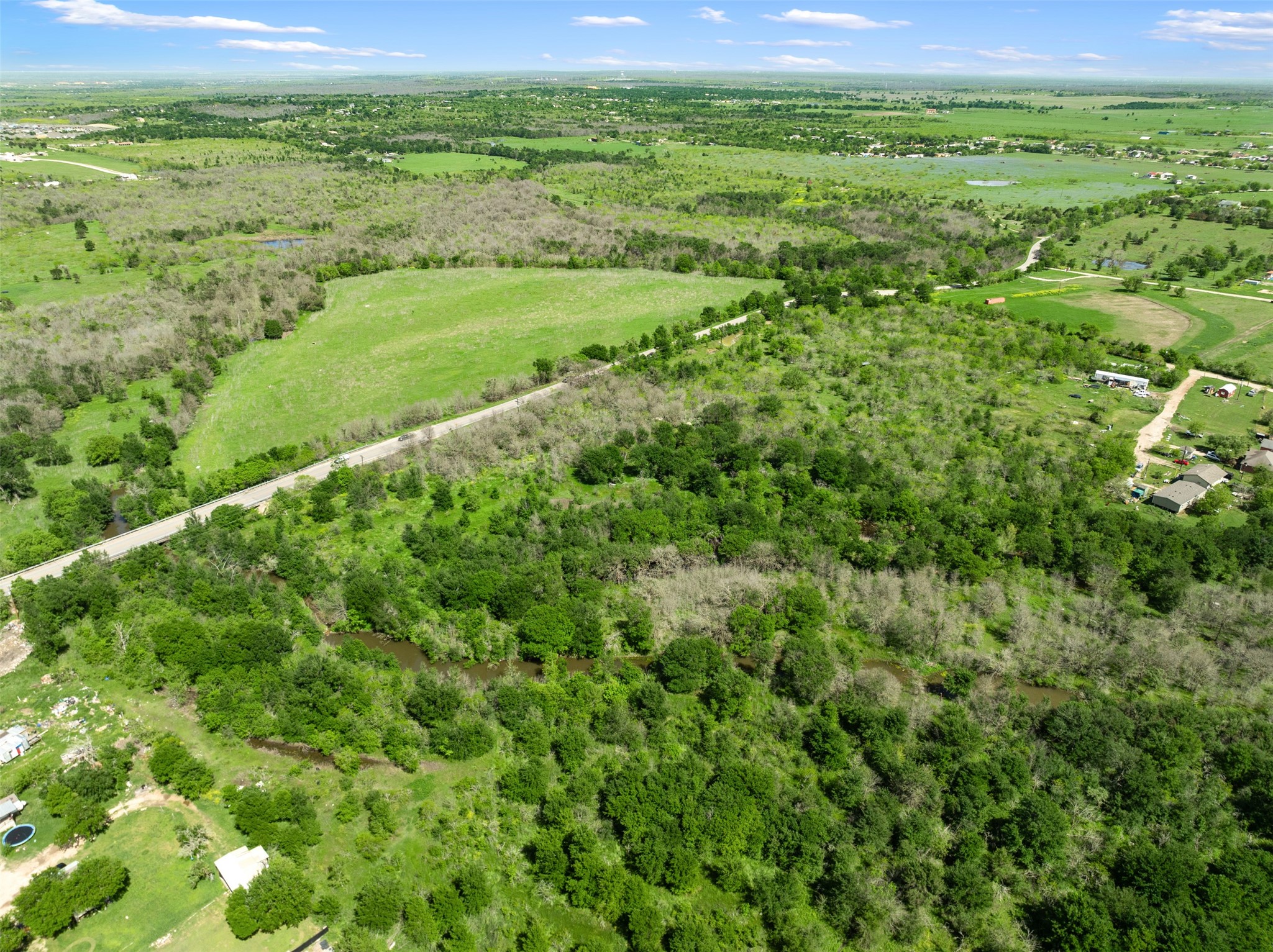 0 Jacobson Road Del Valle, TX 78617 - Photo 13 of 40 a view of a green field with lots of bushes
