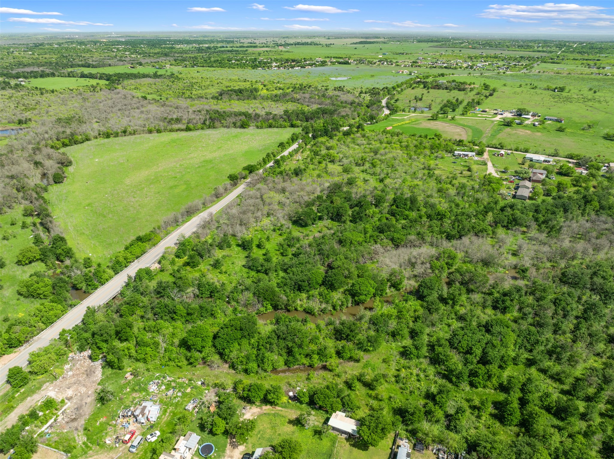 0 Jacobson Road Del Valle, TX 78617 - Photo 15 of 40 a view of a green field with lots of bushes