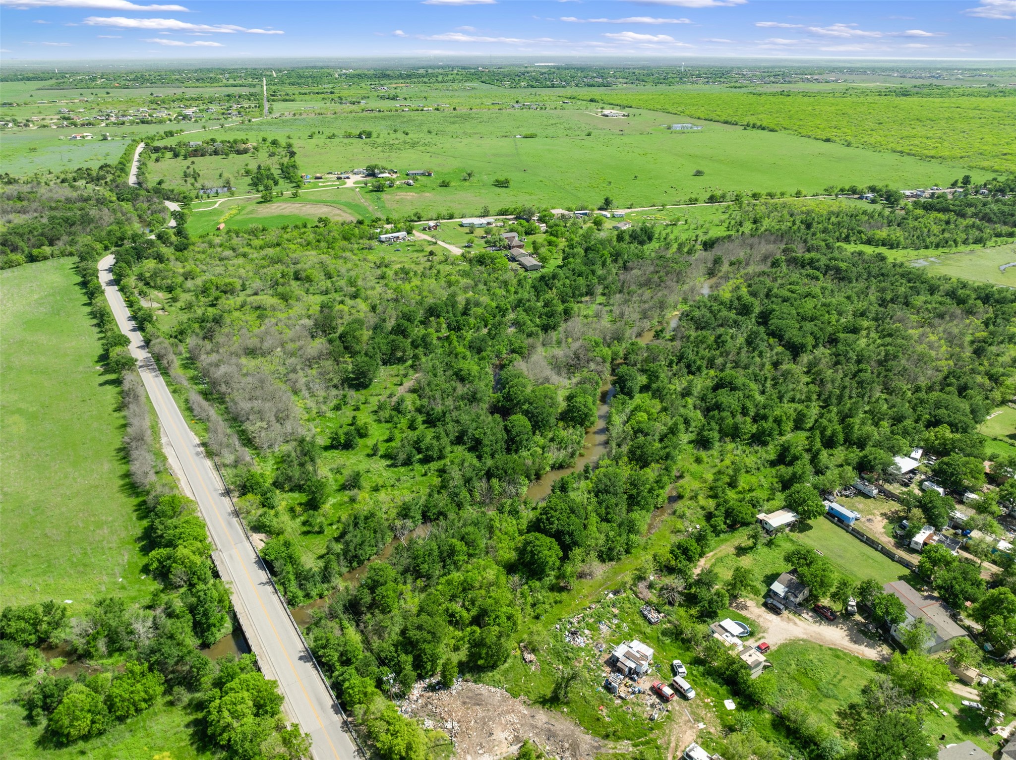 0 Jacobson Road Del Valle, TX 78617 - Photo 16 of 40 a view of a green field with lots of bushes